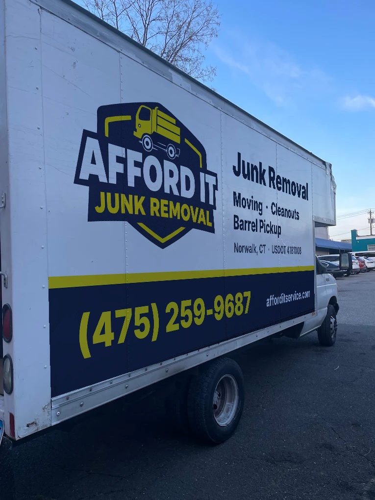 Afford It Junk Removal box truck with the company logo, services and phone number on the side