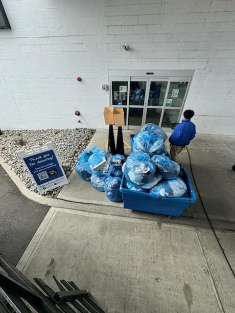 Bags of usable items unloaded at a donation center drop-off