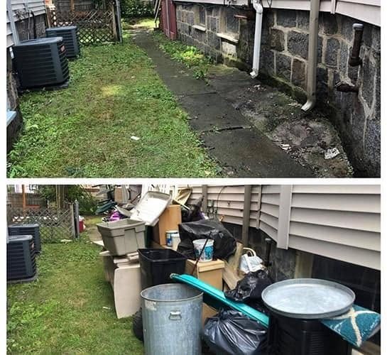 Side yard cleanout, with the cleared walkway on top and the piled bins and boxes before pickup below